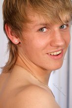 Happy-looking blonde twink happily dry-humping the bed