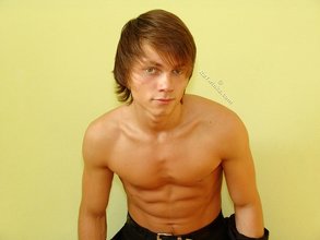 Long-haired twink posing seductively on camera