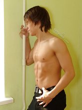 Long-haired twink posing seductively on camera