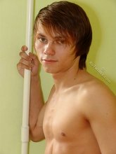 Long-haired twink posing seductively on camera