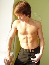 Long-haired twink posing seductively on camera