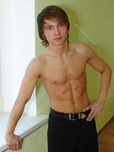 Long-haired twink posing seductively on camera