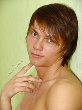 Long-haired twink posing seductively on camera