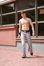 Jacked-up parkour dude posing shirtless outdoors