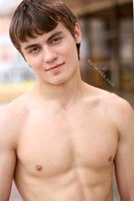 Jacked-up parkour dude posing shirtless outdoors