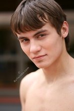 Jacked-up parkour dude posing shirtless outdoors