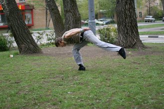Jacked-up parkour dude posing shirtless outdoors