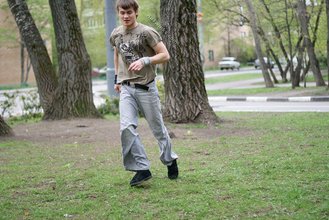 Jacked-up parkour dude posing shirtless outdoors