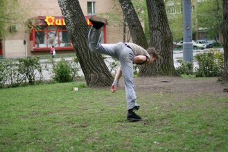 Jacked-up parkour dude posing shirtless outdoors