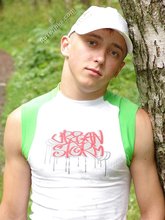 Baseball cap and jorts-wearing twink posing outdoors