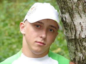 Baseball cap and jorts-wearing twink posing outdoors