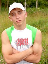 Baseball cap and jorts-wearing twink posing outdoors