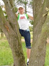 Baseball cap and jorts-wearing twink posing outdoors