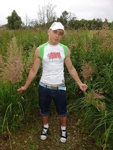 Baseball cap and jorts-wearing twink posing outdoors
