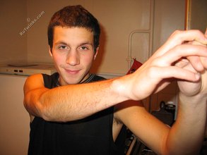 Cool dude takes off his black sleeveless t-shirt