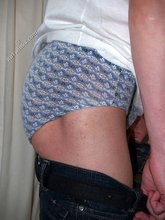 Teen guy showing off his asshole next to a window