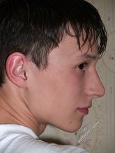 Teen guy showing off his asshole next to a window