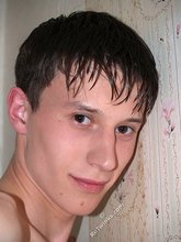 Dark-haired twink playing with his tongue and showing his ass