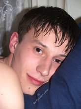 Dark-haired twink playing with his tongue and showing his ass