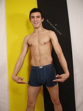 Dark-haired young boy taking his sexy jeans off