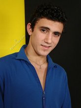 Curly-haired twink seducing with his six-pack