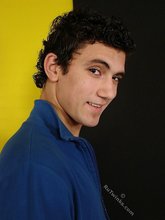 Curly-haired twink seducing with his six-pack
