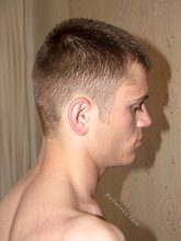 Serious-looking twink boy showing his meaty cock to you
