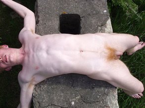 Redheaded twink posing completely naked outdoors