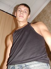 Wife-beater wearing twink boy shows off his impressive body