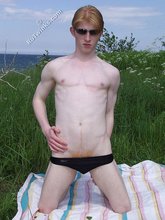 Redheaded twink exposes his creamy ass outdoors
