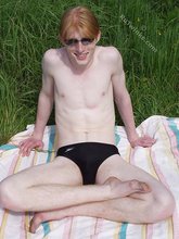 Redheaded twink exposes his creamy ass outdoors