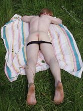 Redheaded twink exposes his creamy ass outdoors