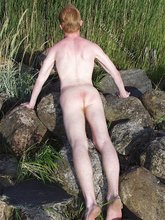 Redheaded hottie posing with his ass submerged