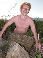 Redheaded hottie posing with his ass submerged