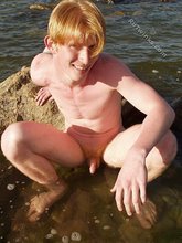 Redheaded hottie posing with his ass submerged