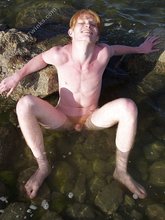 Redheaded hottie posing with his ass submerged