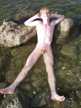 Redheaded hottie posing with his ass submerged