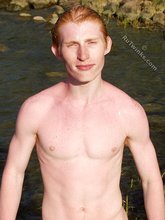 Redheaded hottie posing with his ass submerged