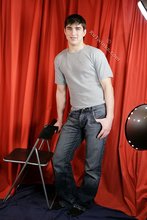 Dark-haired guy flaunting his six pack on camera