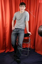 Dark-haired guy flaunting his six pack on camera