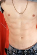 Dark-haired guy flaunting his six pack on camera