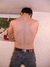 Dark-haired dude teasing his own junk on camera