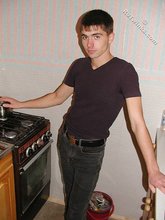 Dark-haired twink posing shirtless on camera