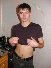 Dark-haired twink posing shirtless on camera