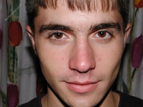Dark-haired twink posing shirtless on camera