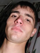 Dark-haired twink posing shirtless on camera