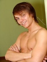 Long-haired pretty boy showing off in the kitchen
