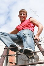 Red wife-beater twink shows off his six-pack outdoors