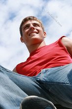 Red wife-beater twink shows off his six-pack outdoors