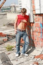 Red wife-beater twink shows off his six-pack outdoors